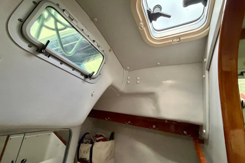 Kittywake Yacht Photos Pics Interior cabin view of a 1996 J Boats J/42 sailboat, featuring a window and storage hooks.