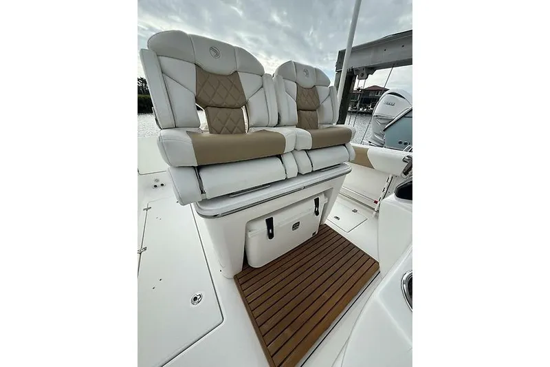  Yacht Photos Pics 2022 Edgewater 262CC boat with cushioned seating and wooden deck detail.