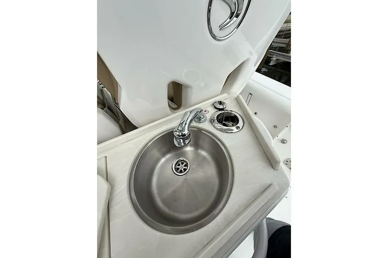  Yacht Photos Pics Stainless steel sink on 2022 Edgewater 262CC boat, featuring modern faucet and clean design.