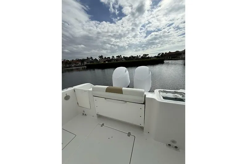  Yacht Photos Pics 2022 Edgewater 262CC boat with dual engines on a calm water backdrop.