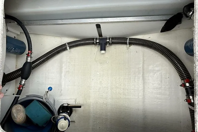  Yacht Photos Pics 2022 Edgewater 262CC boat interior showing hoses and equipment in storage compartment.