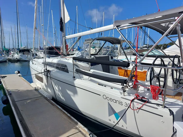 "makai" Yacht Photos Pics 2020 Beneteau Oceanis 30.1 sailboat docked in a marina, surrounded by other boats.