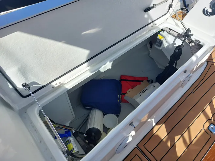 "makai" Yacht Photos Pics Storage compartment on a 2020 Beneteau Oceanis 30.1 sailboat, containing various boating equipment.