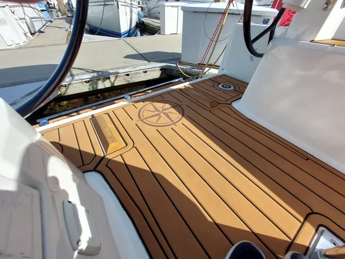 "makai" Yacht Photos Pics Beneteau Oceanis 30.1 cockpit with teak flooring, featuring a compass rose design, 2020 model.
