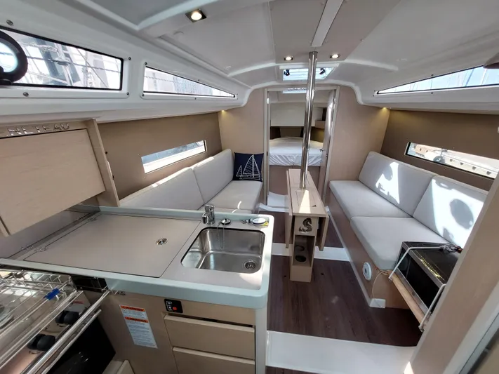 "makai" Yacht Photos Pics Interior of 2020 Beneteau Oceanis 30.1 yacht, featuring modern kitchen and seating area.