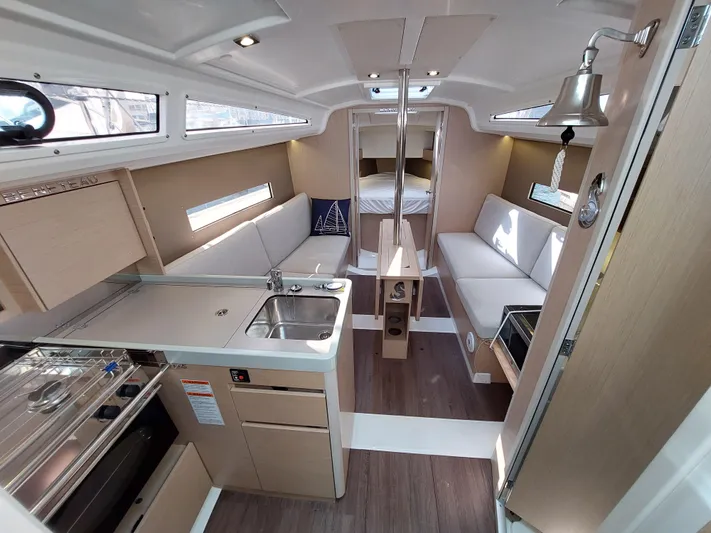 "makai" Yacht Photos Pics Interior of 2020 Beneteau Oceanis 30.1 yacht, featuring modern kitchen and cozy seating area.