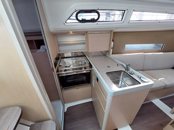 "makai" Yacht Photos Pics Interior of 2020 Beneteau Oceanis 30.1 yacht, featuring a compact kitchen and seating area.