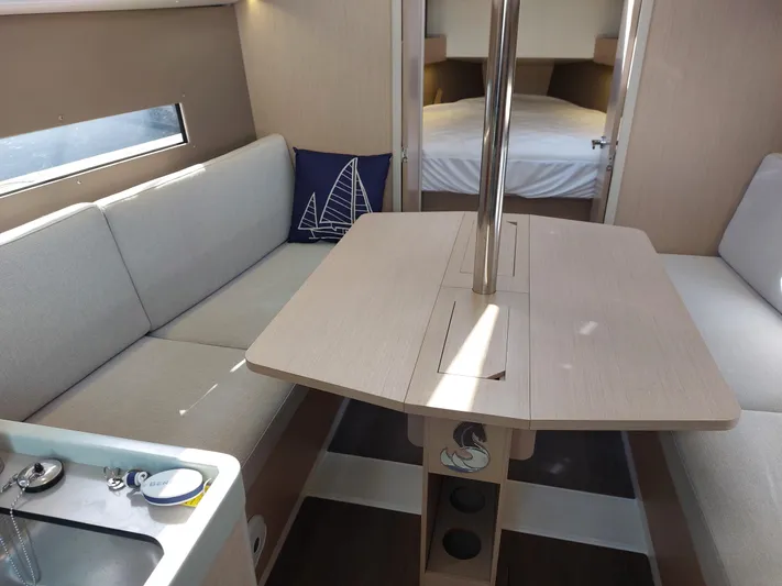 "makai" Yacht Photos Pics Interior of 2020 Beneteau Oceanis 30.1 yacht with cozy seating and dining area.