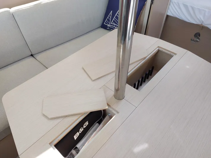 "makai" Yacht Photos Pics Interior of 2020 Beneteau Oceanis 30.1 yacht with table storage compartments.