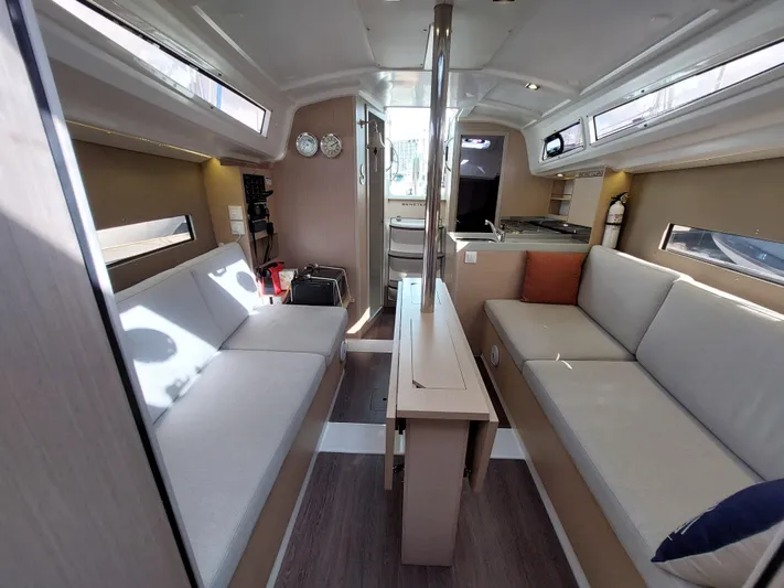 "makai" Yacht Photos Pics Interior of 2020 Beneteau Oceanis 30.1 yacht, featuring modern seating and compact kitchen.