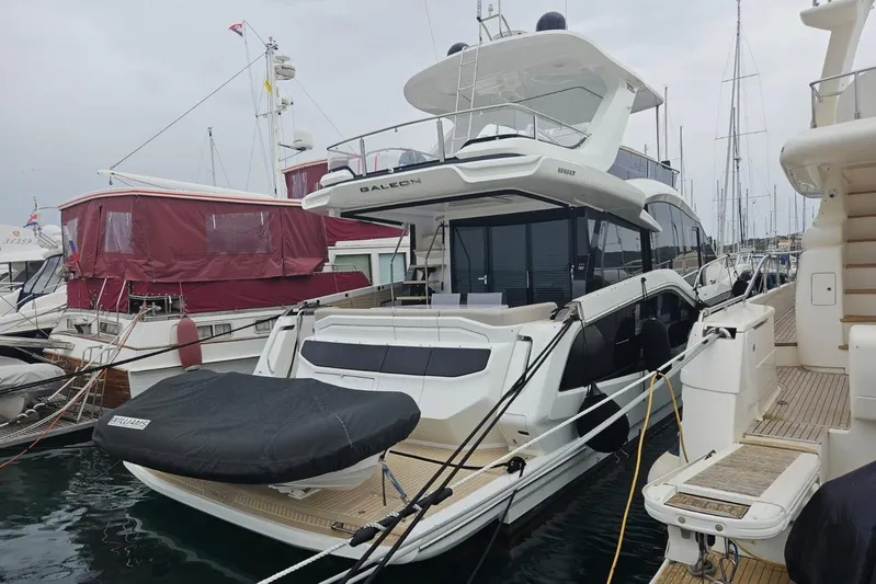  Yacht Photos Pics 2024 Galeon 560 Fly yacht docked at marina, showcasing sleek design and modern features.