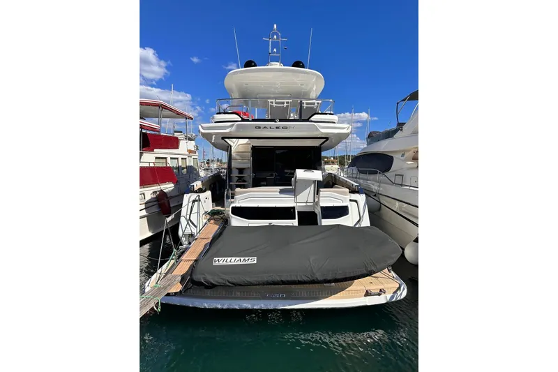  Yacht Photos Pics 2024 Galeon 560 Fly yacht docked, featuring a covered Williams tender on the deck.