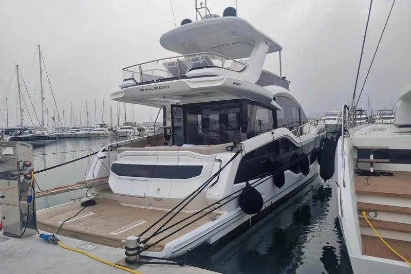  Yacht Photos Pics 2024 Galeon 560 Fly yacht docked at marina, showcasing sleek design and modern features.