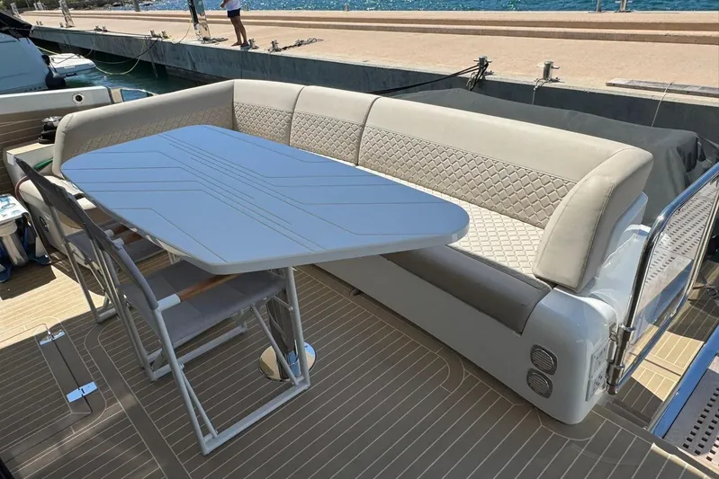  Yacht Photos Pics Luxury seating area on 2024 Galeon 560 Fly yacht with elegant table and chairs.