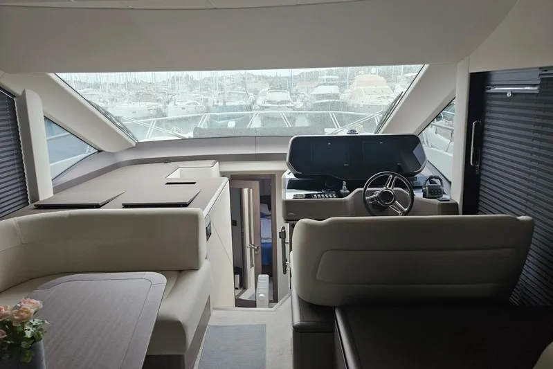  Yacht Photos Pics Interior of 2024 Galeon 560 Fly yacht with modern helm and seating area.