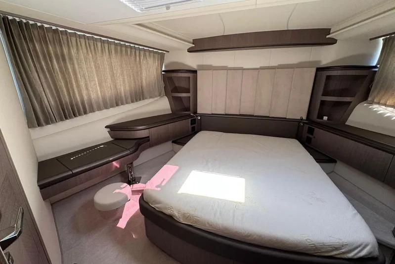  Yacht Photos Pics Luxurious bedroom interior of 2024 Galeon 560 Fly yacht with modern design and elegant furnishings.