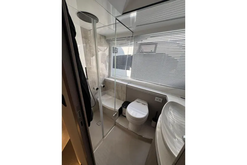  Yacht Photos Pics Luxurious bathroom in 2024 Galeon 560 Fly yacht with modern fixtures and glass shower.