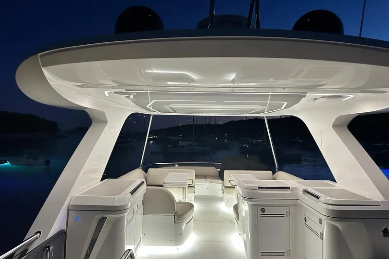  Yacht Photos Pics Luxurious 2024 Galeon 560 Fly yacht interior at night, featuring elegant seating and ambient lighting.