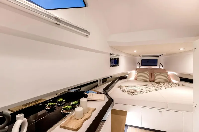  Yacht Photos Pics Luxurious interior of 2026 Fjord 39 XP yacht with cozy bed and modern decor.