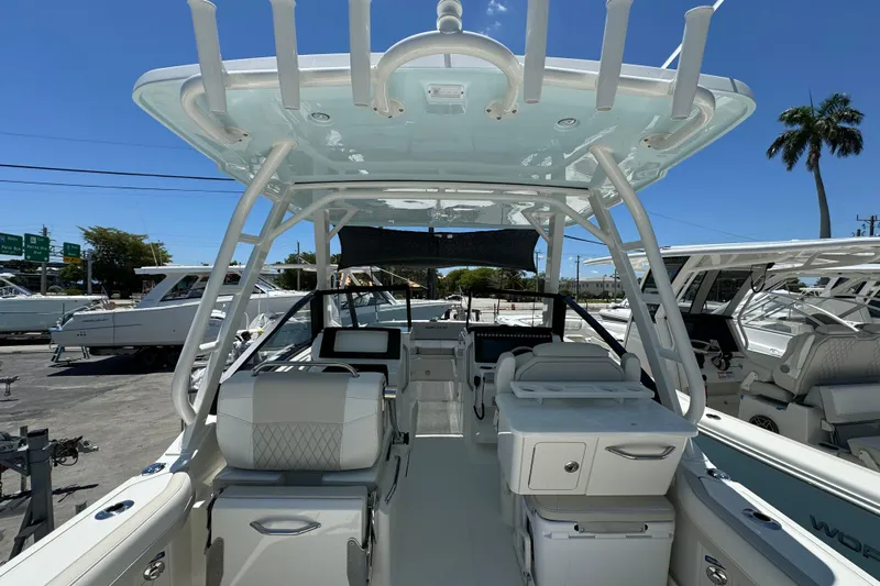 57800 265dc Sf Yacht Photos Pics 2026 World Cat 265 DC-X boat interior with seating and helm, under clear blue sky.