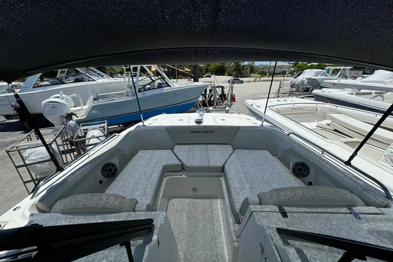 57800 265dc Sf Yacht Photos Pics 2026 World Cat 265 DC-X boat interior with seating and speakers at a marina.
