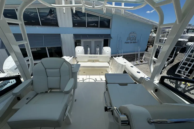 57800 265dc Sf Yacht Photos Pics 2026 World Cat 265 DC-X boat interior with seating and helm, docked at a marina.