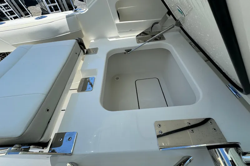 57800 265dc Sf Yacht Photos Pics 2026 World Cat 265 DC-X boat storage compartment with cushioned seating and stainless steel hardware.