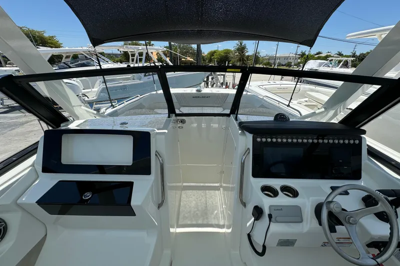 57800 265dc Sf Yacht Photos Pics Interior view of 2026 World Cat 265 DC-X boat cockpit with modern controls and steering.