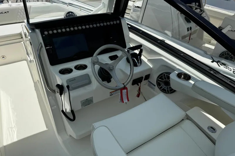 57800 265dc Sf Yacht Photos Pics 2026 World Cat 265 DC-X boat cockpit with steering wheel and control panel.