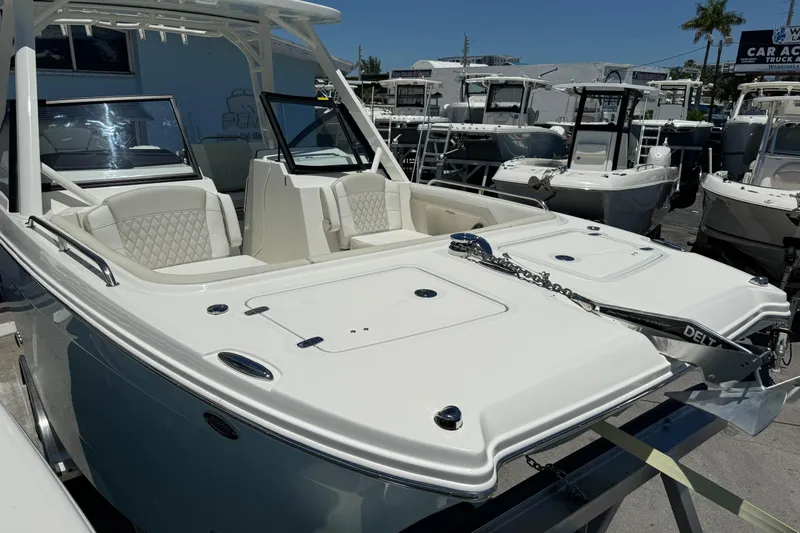 57800 265dc Sf Yacht Photos Pics 2026 World Cat 265 DC-X boat displayed at a dealership, featuring sleek design and seating.