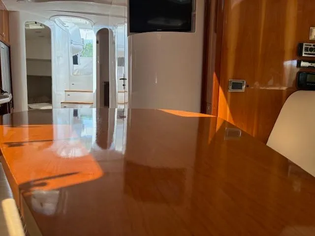  Yacht Photos Pics Interior of 2009 Intrepid 475 Sport Yacht with polished wood table and modern amenities.