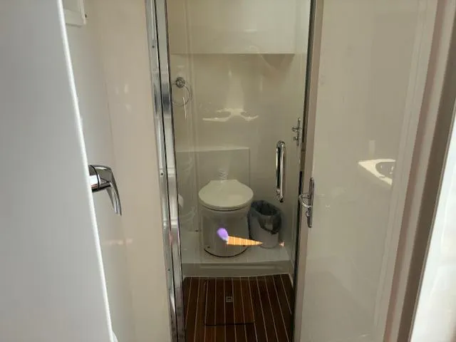  Yacht Photos Pics Bathroom interior of 2009 Intrepid 475 Sport Yacht with wooden flooring and modern fixtures.