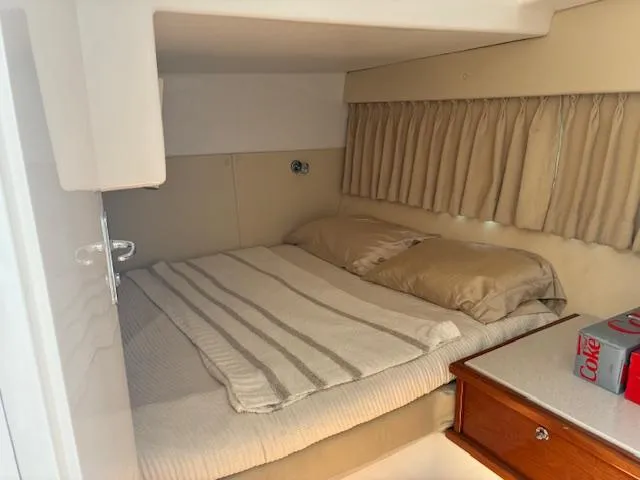  Yacht Photos Pics Cozy cabin interior of 2009 Intrepid 475 Sport Yacht with bed and wooden cabinetry.