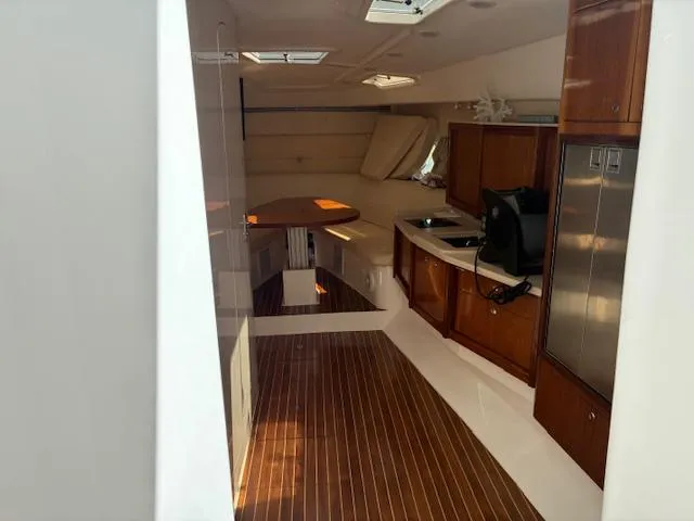  Yacht Photos Pics 2009 Intrepid 475 Sport Yacht interior with wood flooring, kitchenette, and seating area.