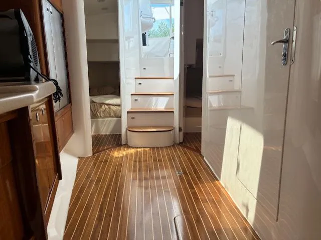  Yacht Photos Pics Interior of 2009 Intrepid 475 Sport Yacht with wooden flooring and cabin access.