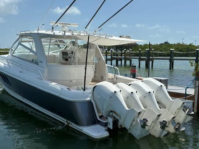  Yacht Photos Pics 2009 Intrepid 475 Sport Yacht with four outboard engines docked by the water.