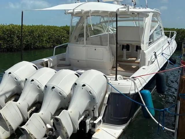  Yacht Photos Pics 2009 Intrepid 475 Sport Yacht with four powerful outboard engines docked in a serene marina.
