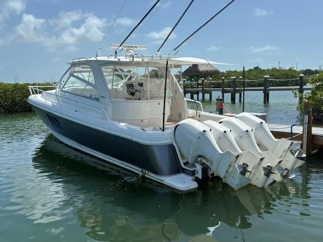  Yacht Photos Pics 2009 Intrepid 475 Sport Yacht with multiple outboard engines docked in a serene marina.