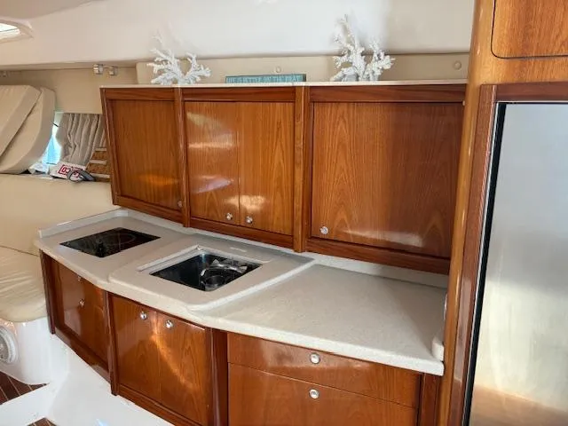  Yacht Photos Pics Luxurious wooden kitchen interior of 2009 Intrepid 475 Sport Yacht with modern appliances.