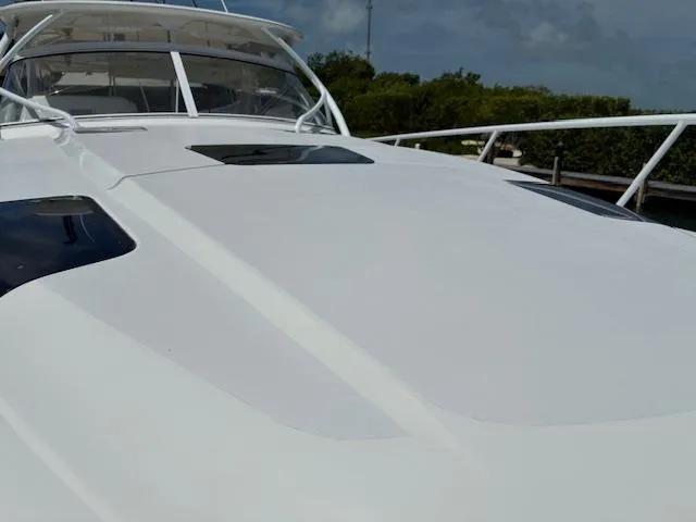  Yacht Photos Pics 2009 Intrepid 475 Sport Yacht, sleek white deck, clear sky background.