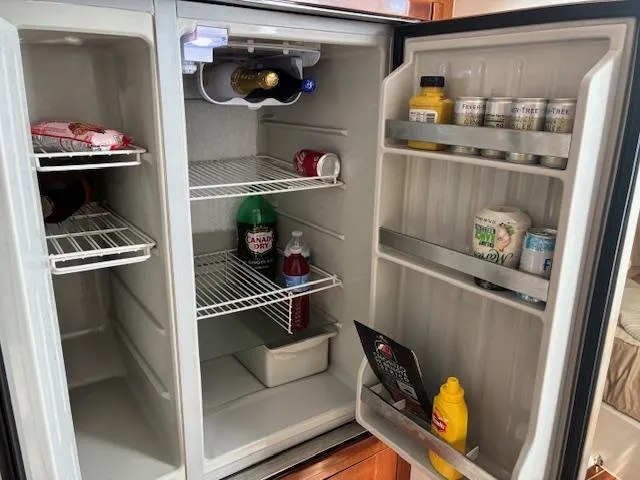  Yacht Photos Pics Open refrigerator on 2009 Intrepid 475 Sport Yacht, stocked with drinks and condiments.