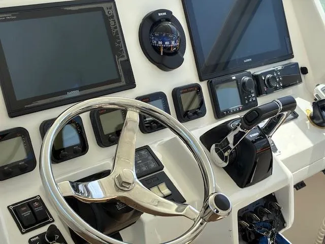  Yacht Photos Pics 2009 Intrepid 475 Sport Yacht helm with steering wheel and navigation instruments.