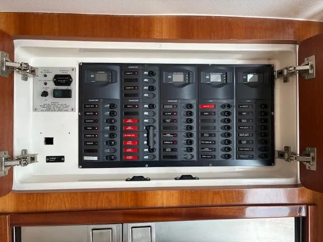  Yacht Photos Pics Electrical panel of a 2009 Intrepid 475 Sport Yacht, featuring multiple switches and controls.