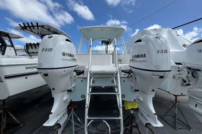 57582 230sd Sf Yacht Photos Pics 2026 World Cat 230 SD boat with dual Yamaha 115 engines, docked under blue sky.