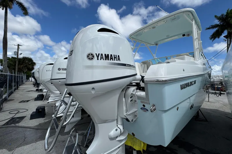 57582 230sd Sf Yacht Photos Pics 2026 World Cat 230 SD boat with Yamaha outboard engines, docked under a blue sky.