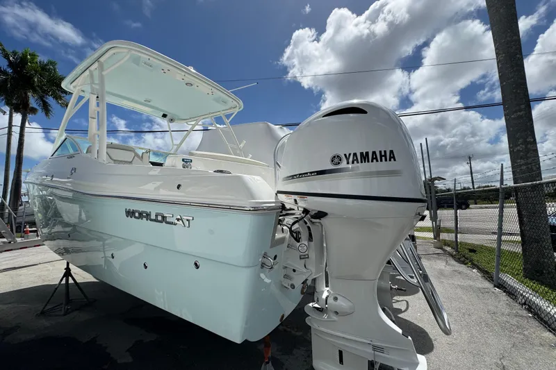 57582 230sd Sf Yacht Photos Pics 2026 World Cat 230 SD boat with Yamaha engine, parked outdoors under a blue sky.