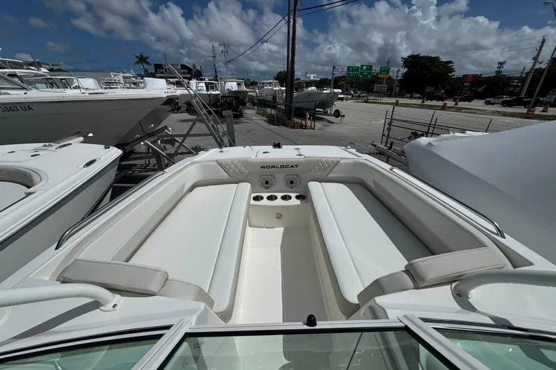 57582 230sd Sf Yacht Photos Pics 2026 World Cat 230 SD boat interior with white seating, parked at a marina.