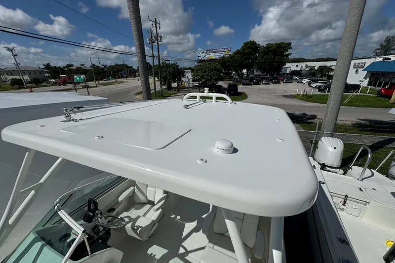 57582 230sd Sf Yacht Photos Pics 2026 World Cat 230 SD boat with sleek white design, parked outdoors under a blue sky.