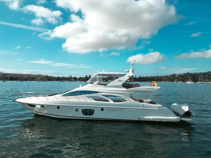 Azimut 62 Evolution Yacht Photos Pics 2007 Azimut 62 Evolution yacht on calm water under a blue sky.