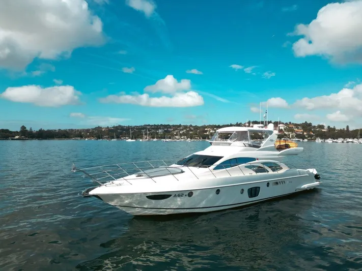 Azimut 62 Evolution Yacht Photos Pics 2007 Azimut 62 Evolution yacht on calm water under a clear blue sky.